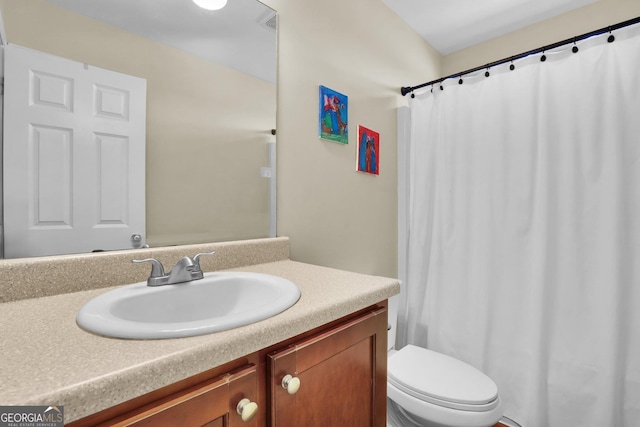 full bath featuring toilet, curtained shower, and vanity