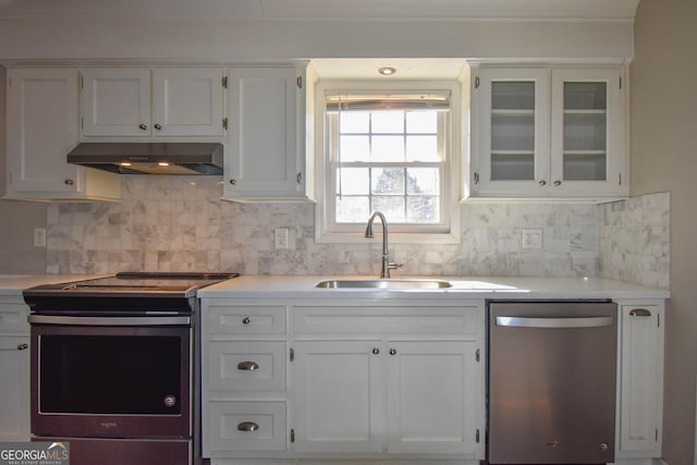 kitchen featuring light countertops, stainless steel appliances, white cabinetry, a sink, and exhaust hood