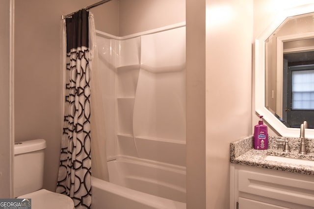 bathroom with shower / bath combo, vanity, and toilet