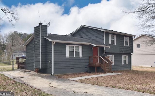 tri-level home with crawl space, fence, and a chimney