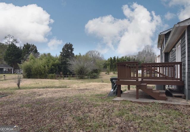 view of yard featuring fence and a deck