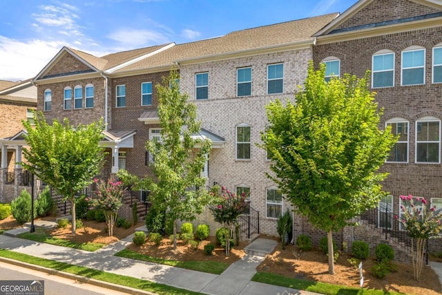 townhome / multi-family property featuring brick siding