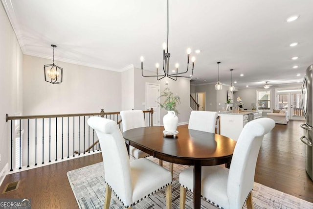 dining area featuring ornamental molding, dark wood-style flooring, visible vents, and recessed lighting