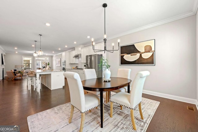 dining room with baseboards, recessed lighting, dark wood finished floors, and crown molding