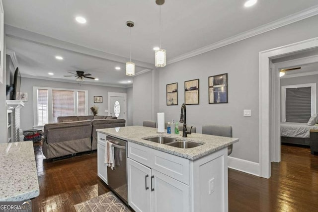 kitchen with white cabinets, open floor plan, a sink, a fireplace, and stainless steel dishwasher