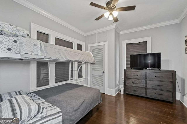 bedroom with baseboards, wood finished floors, a ceiling fan, and crown molding