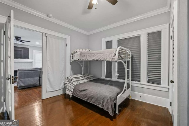 bedroom featuring a ceiling fan, baseboards, crown molding, and hardwood / wood-style floors