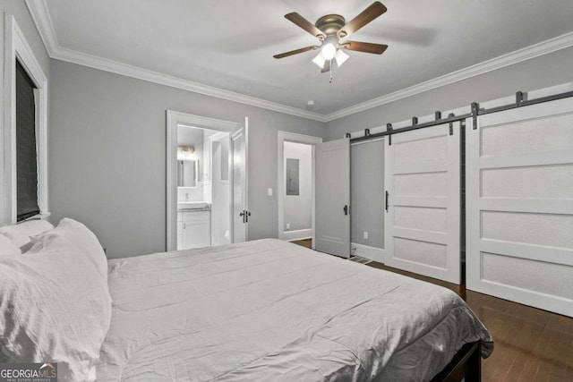 bedroom featuring a barn door, ensuite bath, ceiling fan, ornamental molding, and wood finished floors