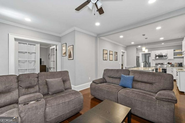 living room featuring crown molding, recessed lighting, dark wood finished floors, and baseboards