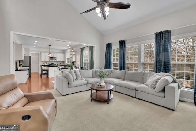 living room with a healthy amount of sunlight, ceiling fan, high vaulted ceiling, and recessed lighting