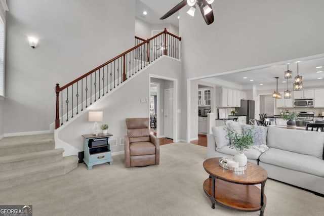 living room with baseboards, stairway, and recessed lighting