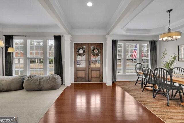 entrance foyer featuring ornamental molding and wood-type flooring