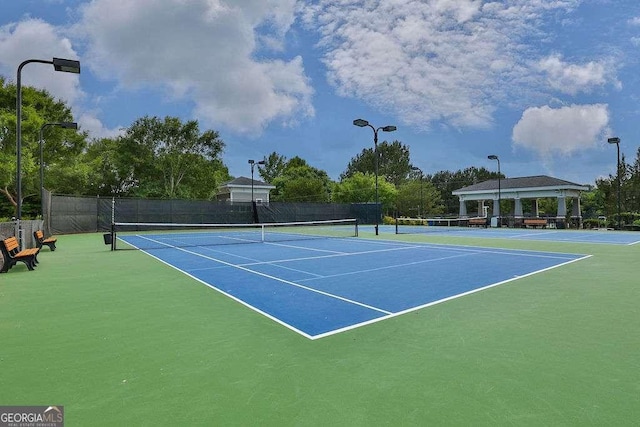 view of sport court featuring fence