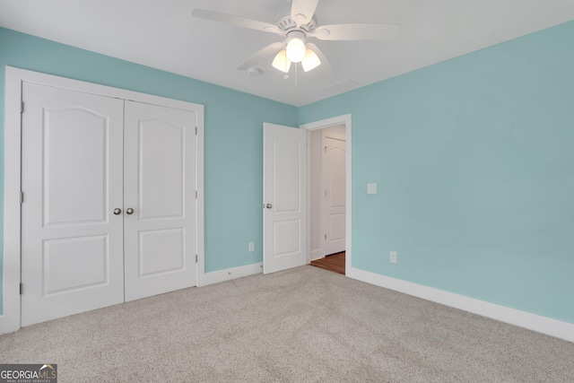 unfurnished bedroom with a ceiling fan, carpet, baseboards, and a closet