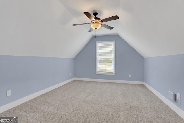 additional living space with ceiling fan, carpet, baseboards, and vaulted ceiling