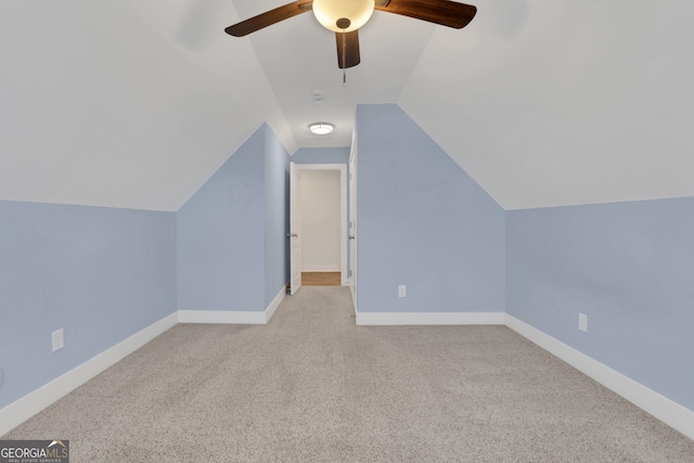 additional living space with lofted ceiling, carpet floors, baseboards, and a ceiling fan