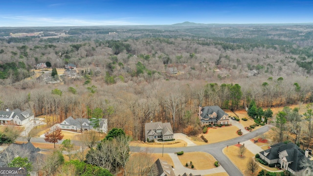 birds eye view of property featuring a view of trees