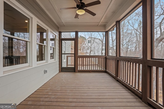 unfurnished sunroom featuring ceiling fan and wooden ceiling