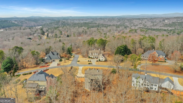 birds eye view of property with a forest view