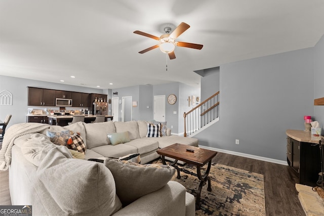 living room featuring dark wood-style floors, recessed lighting, ceiling fan, baseboards, and stairs