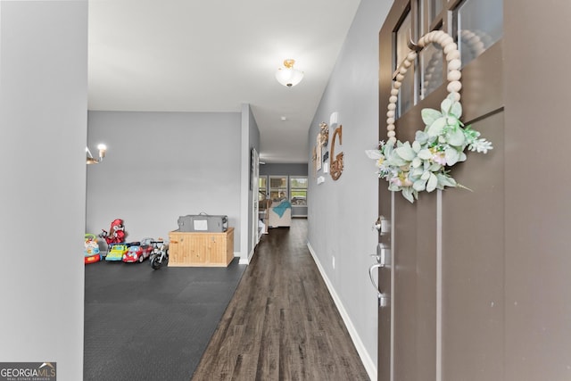 hallway with baseboards and wood finished floors