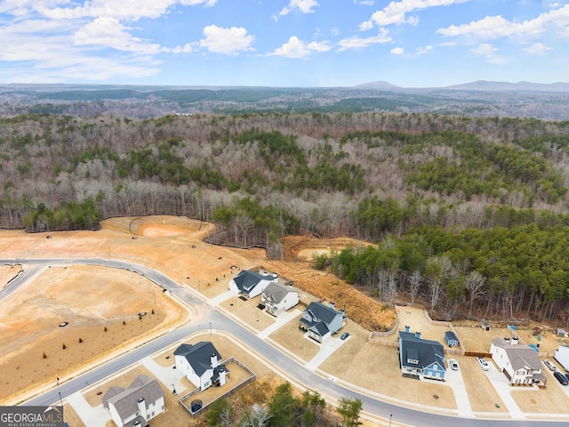 aerial view featuring a mountain view and a forest view