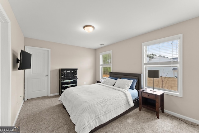 bedroom featuring visible vents and baseboards