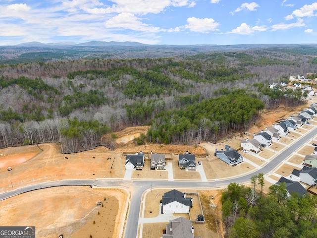 aerial view featuring a mountain view and a wooded view