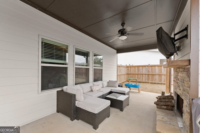 view of patio with ceiling fan, fence, and an outdoor living space