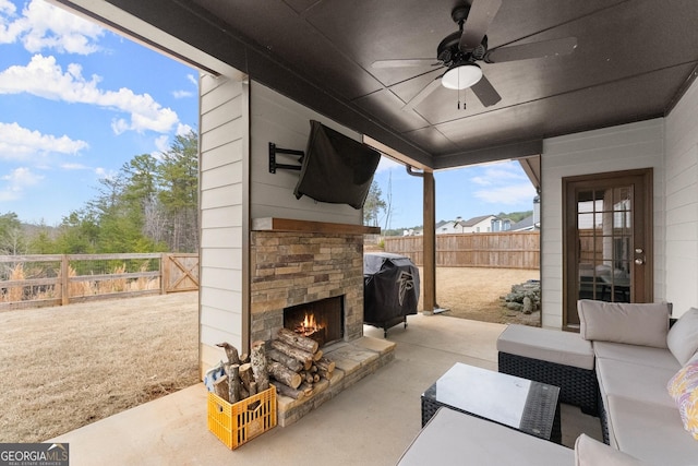 view of patio / terrace with a fenced backyard, a grill, an outdoor living space with a fireplace, and ceiling fan