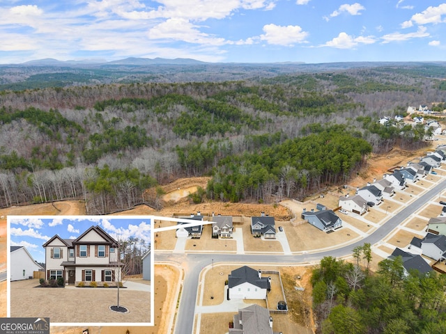 aerial view featuring a forest view and a mountain view