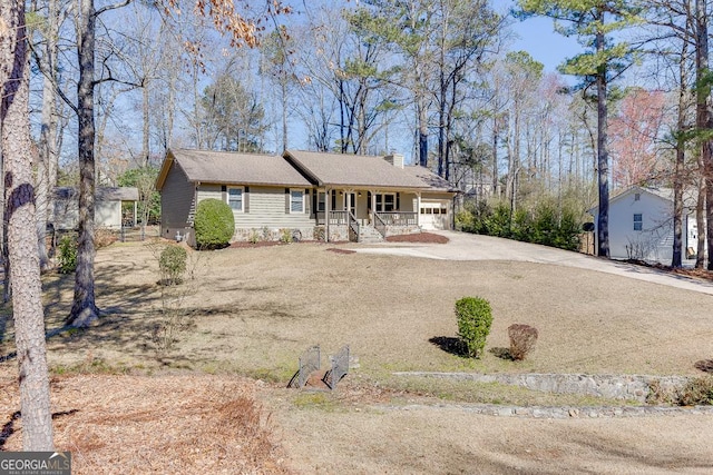 ranch-style home with an attached garage, a chimney, a porch, and concrete driveway