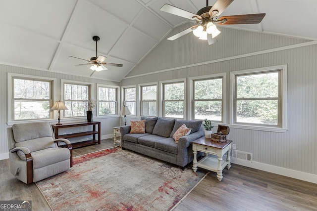 living room with vaulted ceiling, plenty of natural light, and wood finished floors