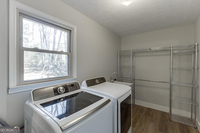 laundry area featuring dark wood-type flooring, plenty of natural light, laundry area, and independent washer and dryer