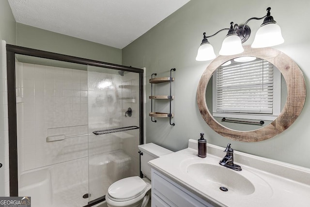 full bathroom with toilet, a shower stall, and vanity