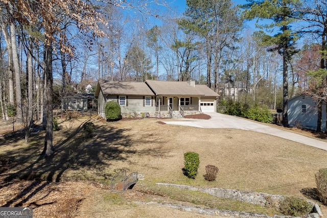 ranch-style home with a porch, a garage, an outdoor structure, concrete driveway, and a chimney