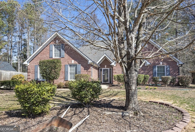 view of front of property with fence and brick siding