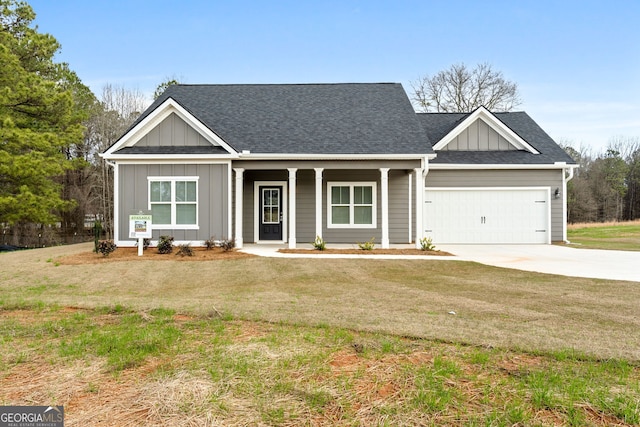 view of front of property featuring driveway, roof with shingles, a porch, board and batten siding, and a front yard