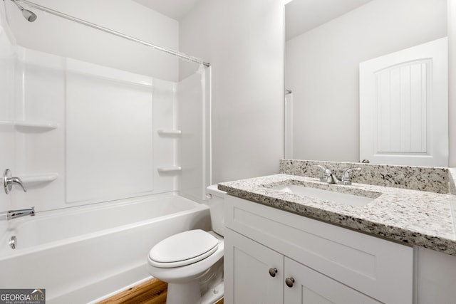 bathroom featuring bathtub / shower combination, vanity, and toilet