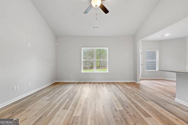 spare room with light wood-style floors, visible vents, baseboards, and a ceiling fan