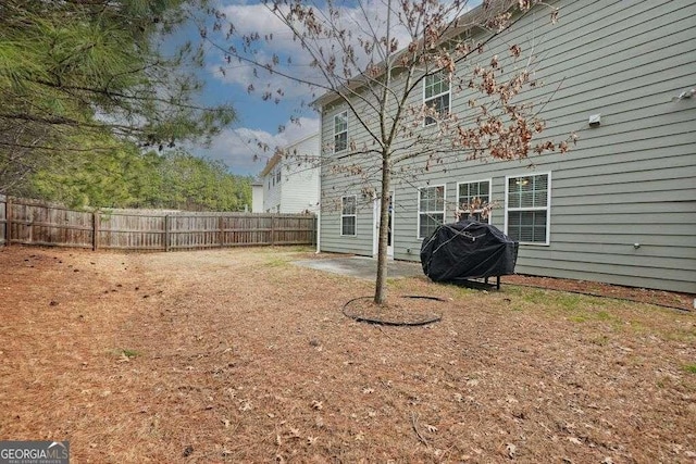 view of yard with fence and a patio