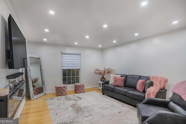 living room featuring ornamental molding, light wood-type flooring, and recessed lighting