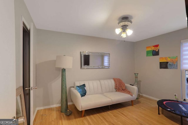 sitting room featuring light wood-style flooring and baseboards