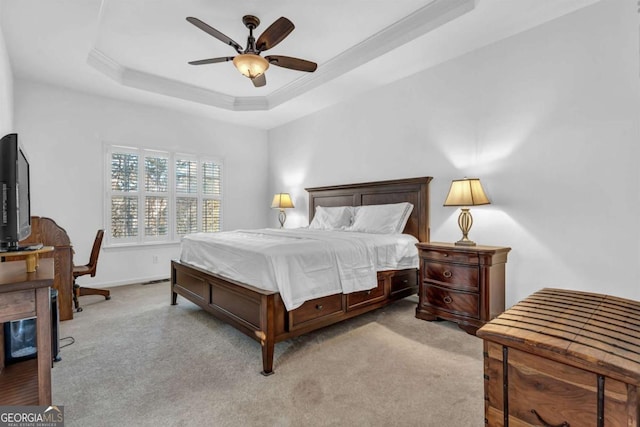 bedroom with carpet, a tray ceiling, baseboards, and ornamental molding