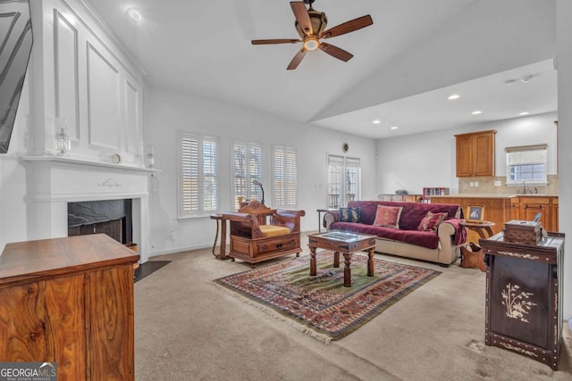 living room featuring ceiling fan, recessed lighting, light colored carpet, a fireplace, and baseboards