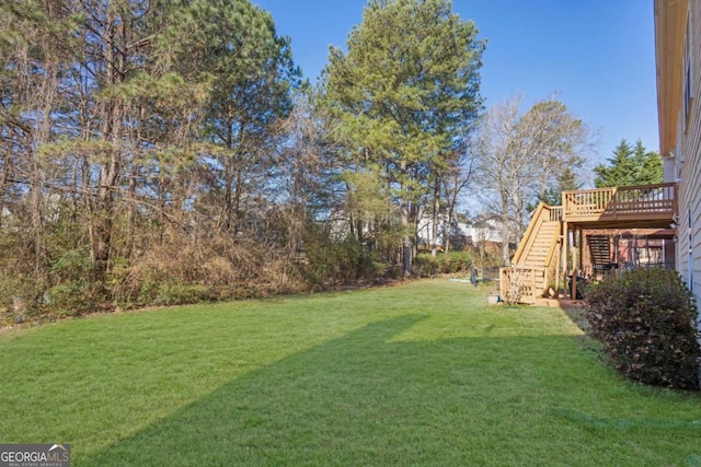 view of yard featuring stairs and a deck