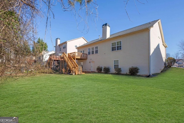 rear view of property with a chimney, a lawn, a deck, and stairs