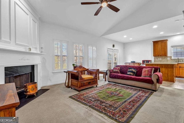 living area featuring ceiling fan, recessed lighting, light carpet, a high end fireplace, and vaulted ceiling