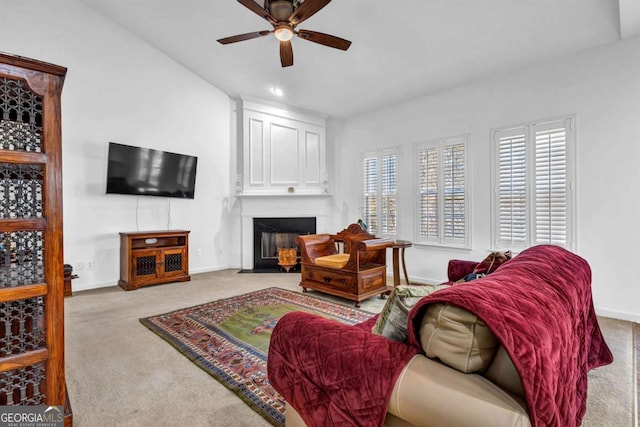 living area with baseboards, a fireplace with flush hearth, ceiling fan, carpet flooring, and recessed lighting