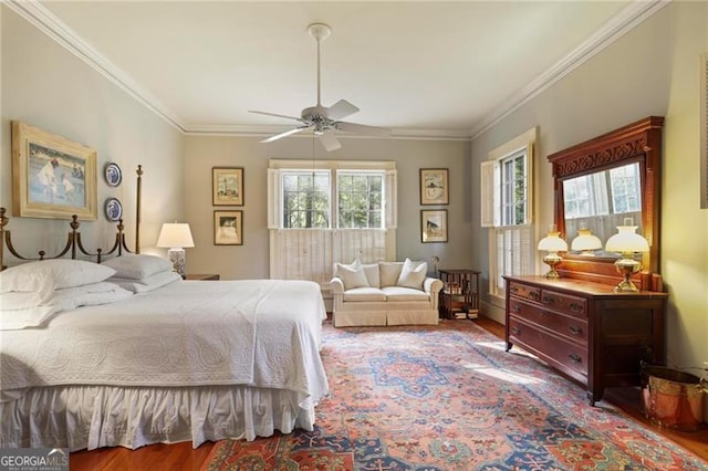 bedroom featuring wood finished floors, ceiling fan, and ornamental molding